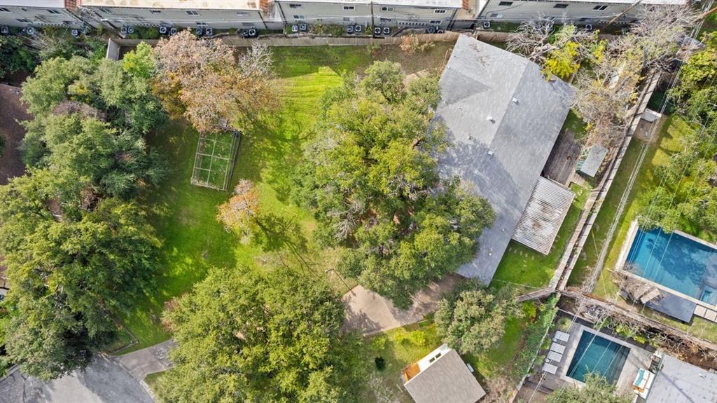 an aerial view of a house with a garden and swimming pool