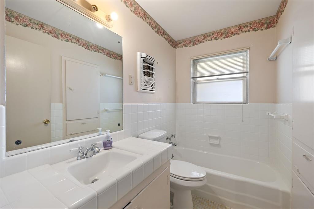 601 Sandringham Circle Austin, TX 78704 - Photo 19 of 40 a bathroom with a sink a toilet and shower