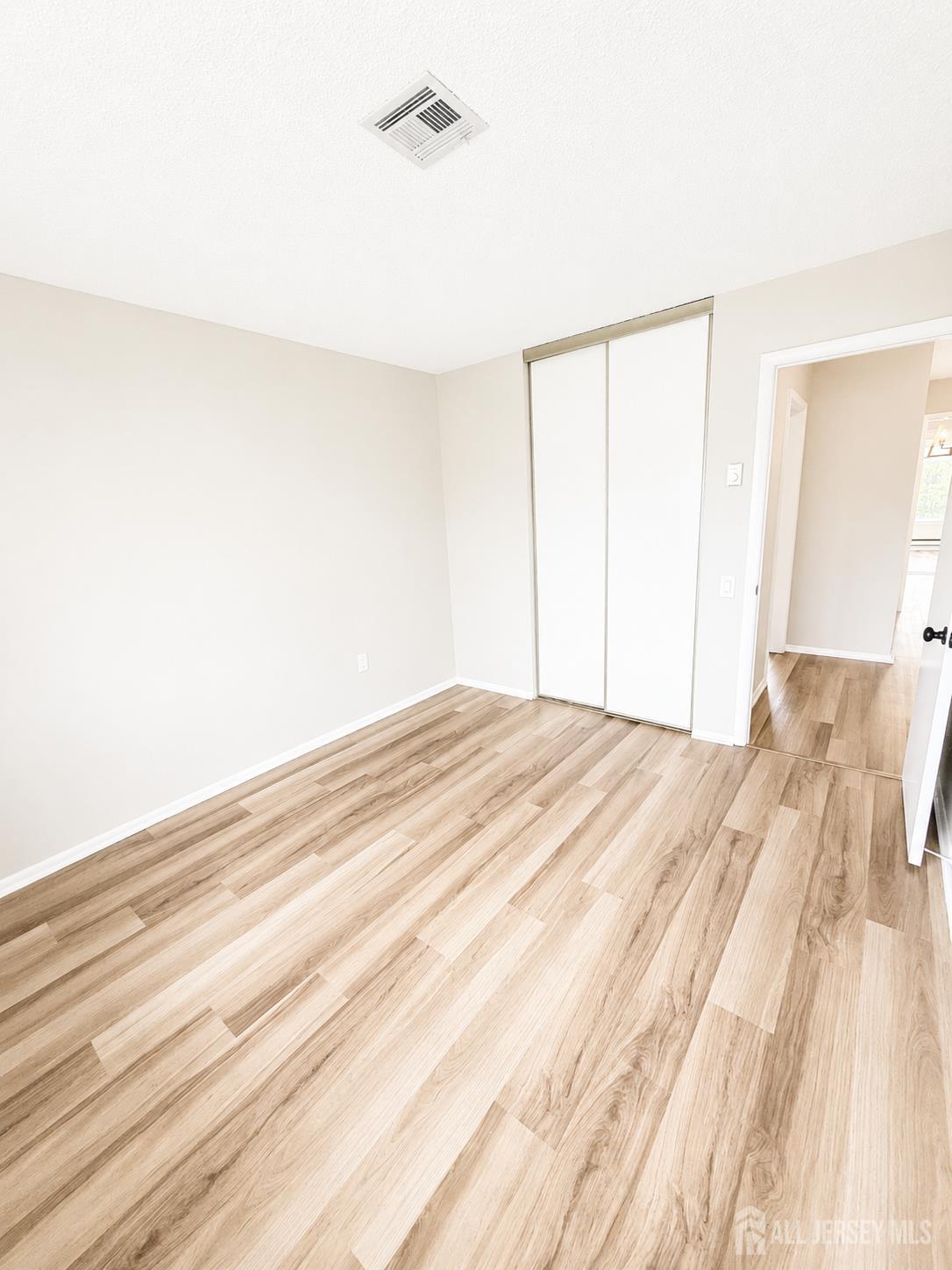 621 A Deal Road Monroe Township, NJ 08831 - Photo 22 of 27 a bedroom with a bed and a mirror