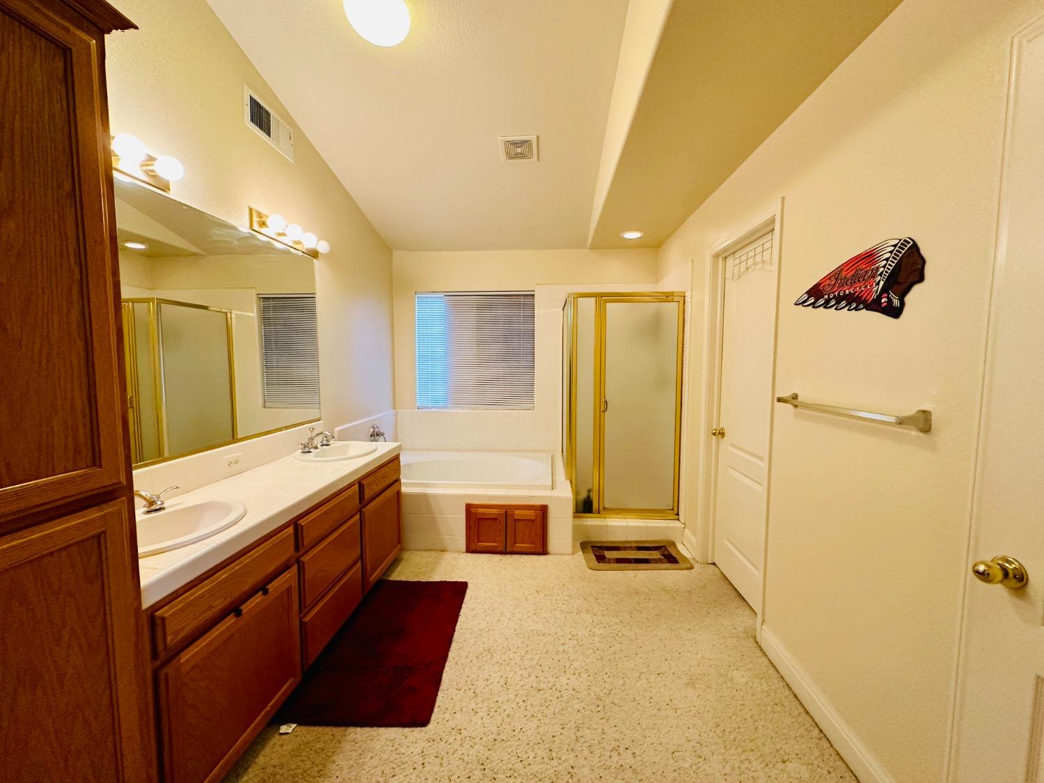 2439 Prescott Avenue Clovis, CA 93619 - Photo 16 of 25 a large bathroom with a tub sink shower and mirror