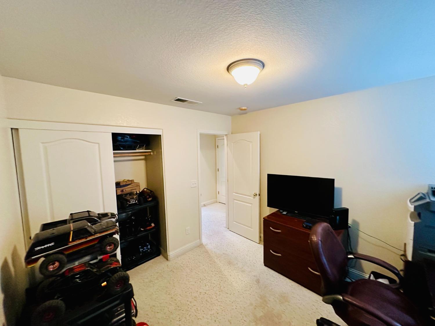 2439 Prescott Avenue Clovis, CA 93619 - Photo 19 of 25 a bedroom with a bed and a flat screen tv