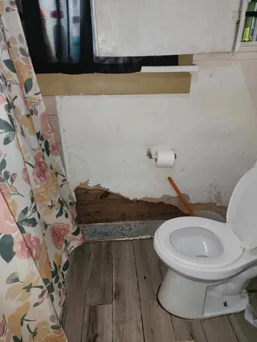 a bathroom with a toilet and a sink