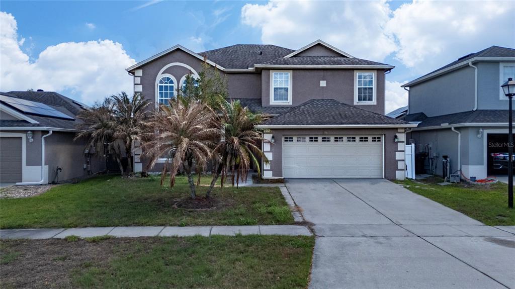 2962 White Cedar Circle Kissimmee, FL 34741 - Photo 1 of 24 a front view of a house with a yard and a garage