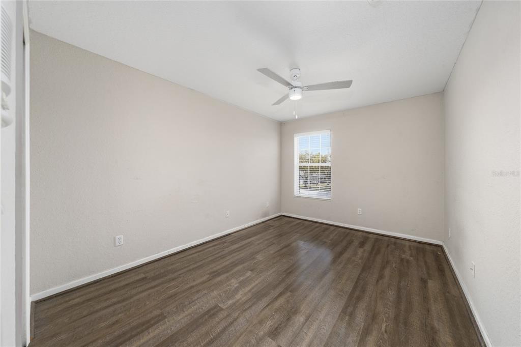 2962 White Cedar Circle Kissimmee, FL 34741 - Photo 15 of 24 an empty room with wooden floor and windows