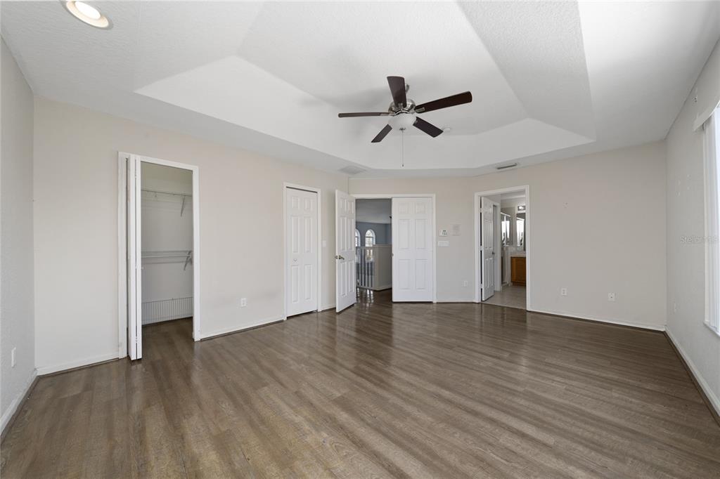 2962 White Cedar Circle Kissimmee, FL 34741 - Photo 19 of 24 a view of empty room with wooden floor and ceiling fan