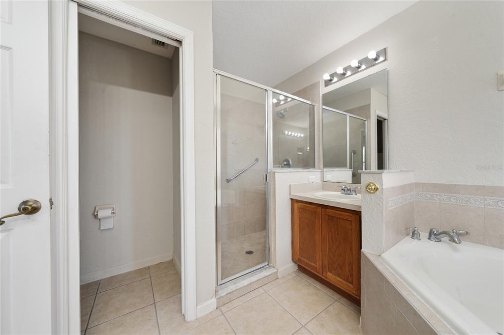 2962 White Cedar Circle Kissimmee, FL 34741 - Photo 20 of 24 a bathroom with a tub sink shower and mirror