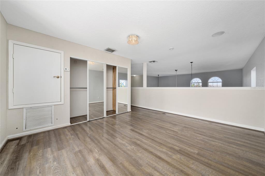2962 White Cedar Circle Kissimmee, FL 34741 - Photo 21 of 24 a view of an empty room with wooden floor