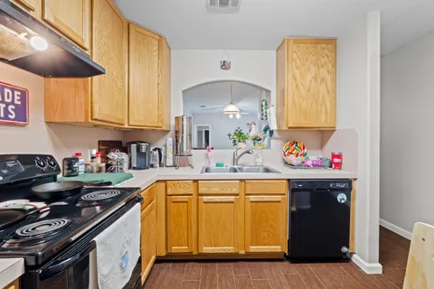 a kitchen with granite countertop a stove and a sink
