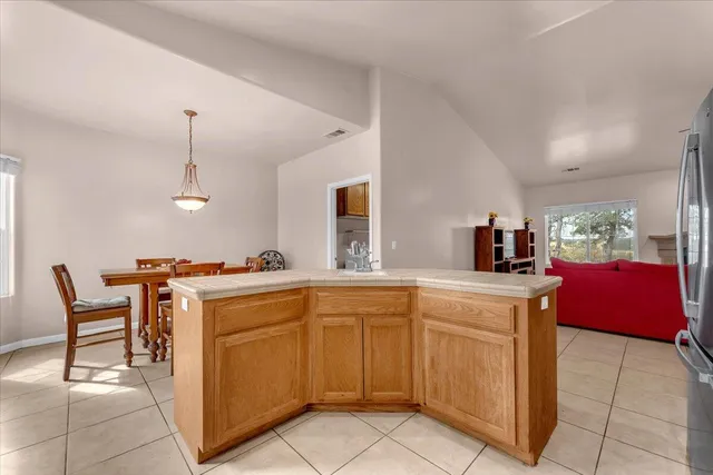a kitchen with a sink and chairs