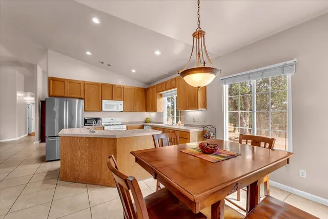 a dining table with chairs and window