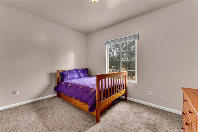 a bed room with a bed and a chair