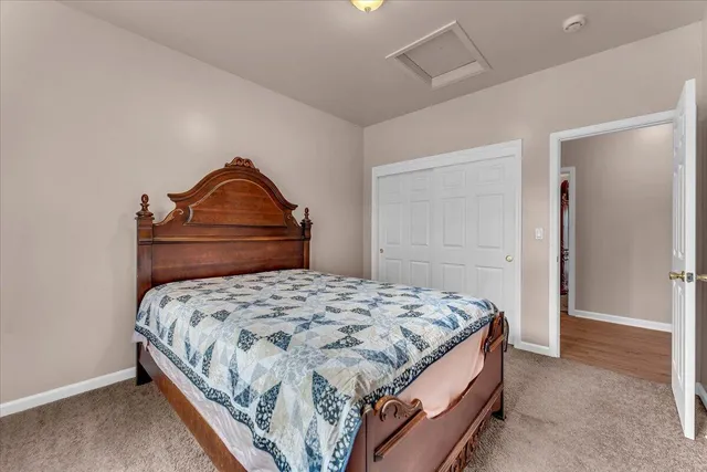 a bedroom with a bed and cabinet