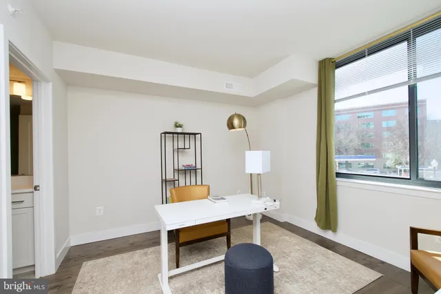 a living room with furniture and a mirror