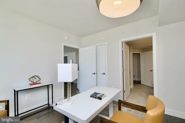 a bathroom with a sink a toilet and a large mirror