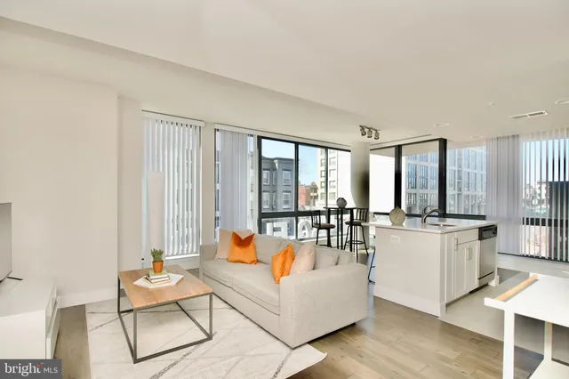 a living room with furniture and large windows