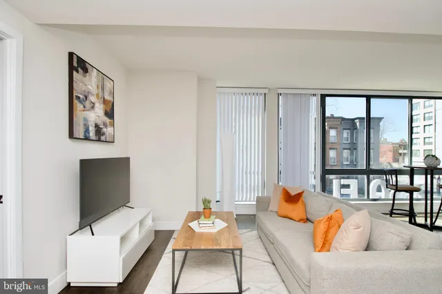 a living room with furniture and large window