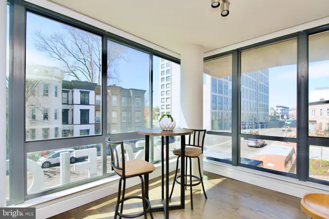 a view of a dining room with furniture large window and wooden floor