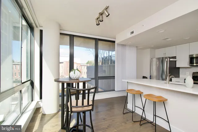 a kitchen with stainless steel appliances granite countertop a sink and a refrigerator