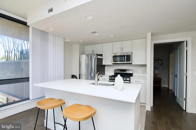 a kitchen with a sink and large window