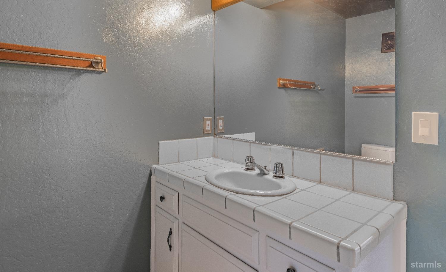 439 Ala Wai Boulevard, Unit 121 South Lake Tahoe, CA 96150 - Photo 15 of 35 a bathroom with a sink and a mirror