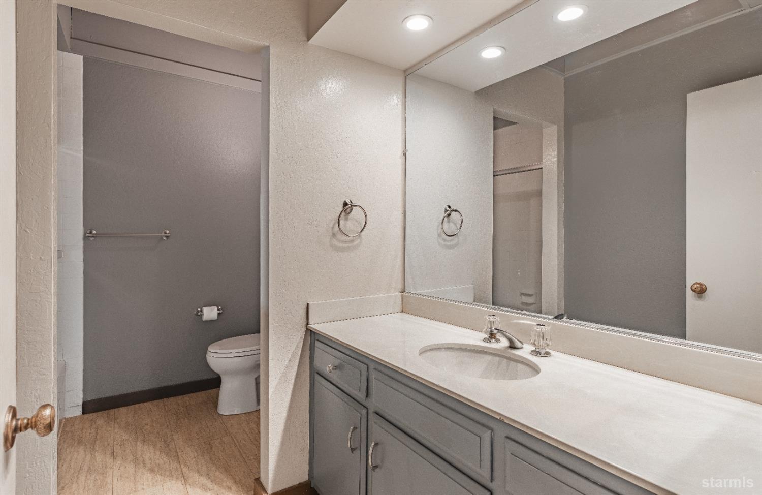 439 Ala Wai Boulevard, Unit 121 South Lake Tahoe, CA 96150 - Photo 17 of 35 a bathroom with a toilet a sink and mirror
