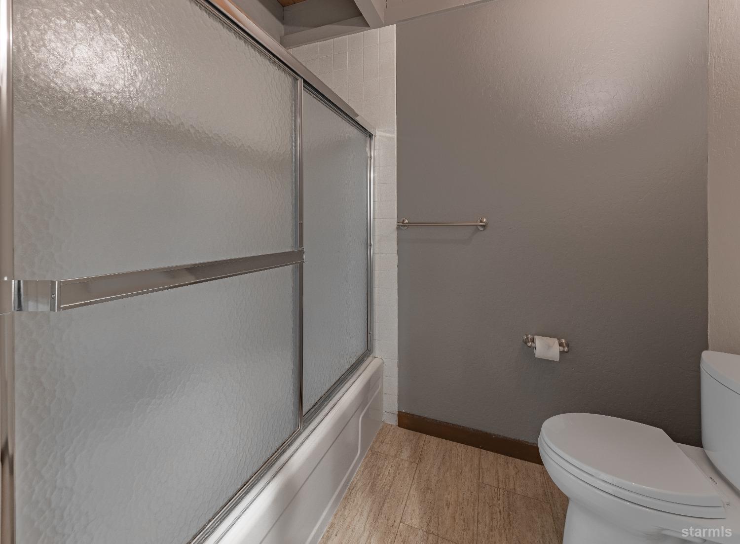 439 Ala Wai Boulevard, Unit 121 South Lake Tahoe, CA 96150 - Photo 18 of 35 a bathroom with a granite countertop toilet and a shower