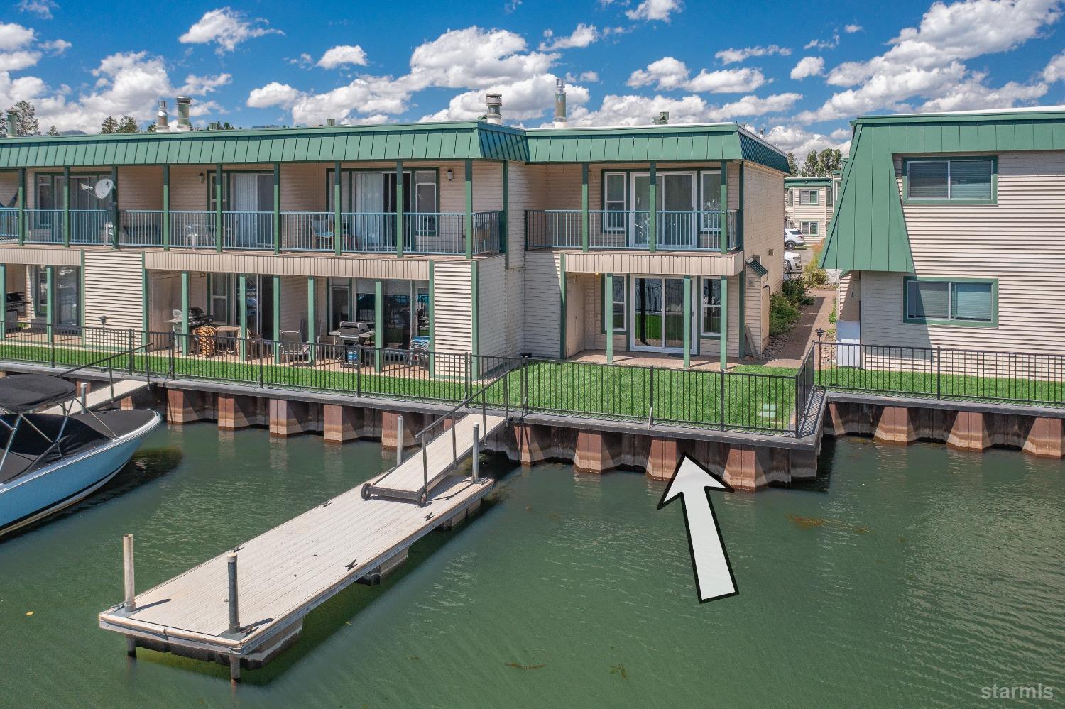 439 Ala Wai Boulevard, Unit 121 South Lake Tahoe, CA 96150 - Photo 2 of 35 a view of a lake with a house and pool table chairs