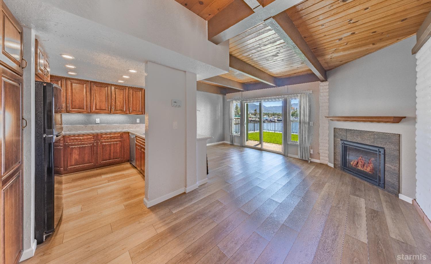 439 Ala Wai Boulevard, Unit 121 South Lake Tahoe, CA 96150 - Photo 3 of 35 a view of a hallway with wooden floor and a kitchen