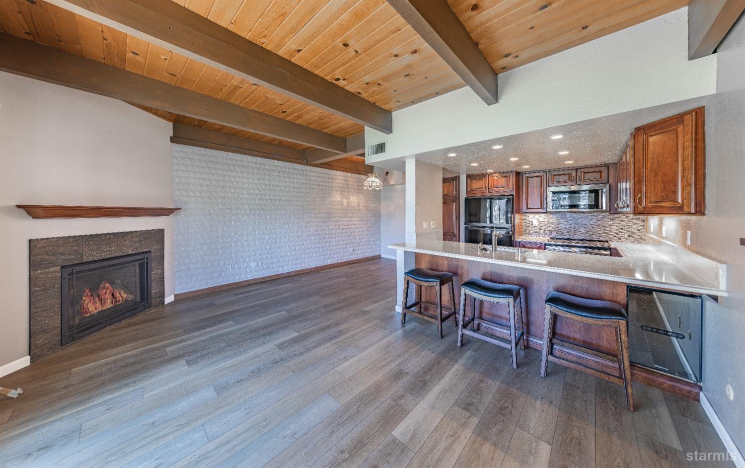 439 Ala Wai Boulevard, Unit 121 South Lake Tahoe, CA 96150 - Photo 4 of 35 a kitchen with a table chairs refrigerator and cabinets