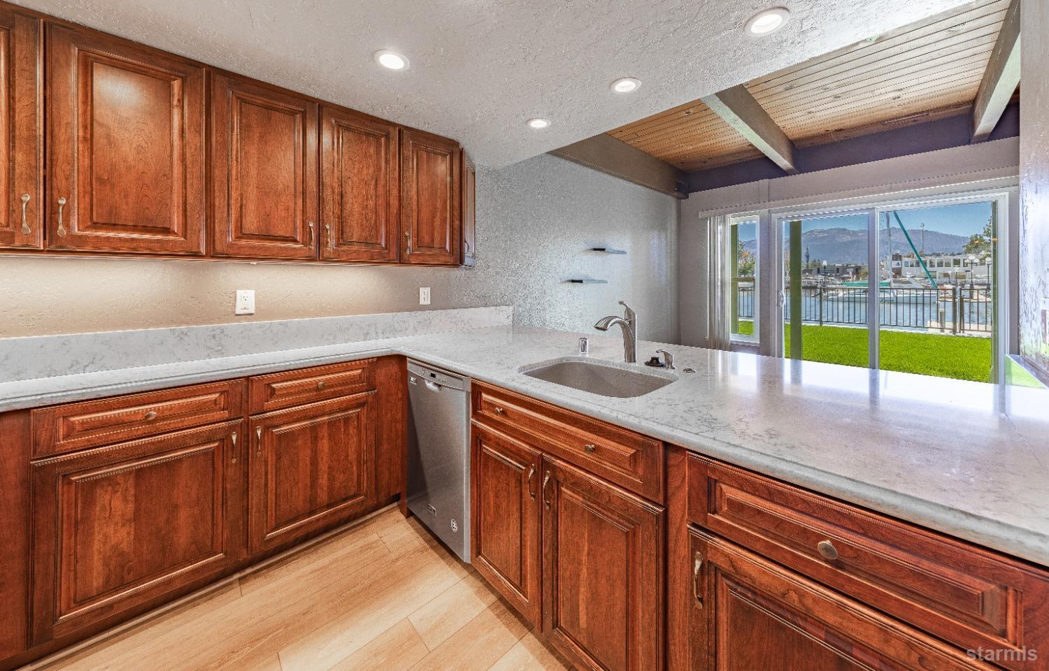 439 Ala Wai Boulevard, Unit 121 South Lake Tahoe, CA 96150 - Photo 8 of 35 a kitchen with stainless steel appliances granite countertop wooden cabinets a sink and dishwasher