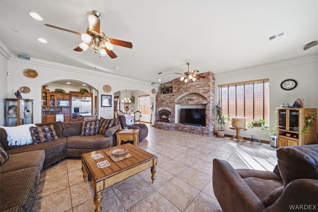 1084 Dike Road Mohave Valley, AZ 86440 - Photo 41 of 75 a living room with furniture a fireplace and a chandelier