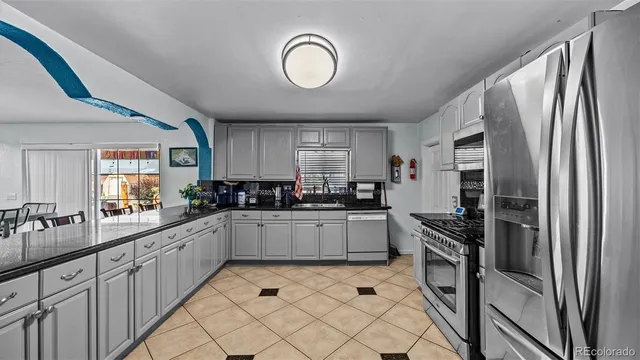 a kitchen with a refrigerator and a sink