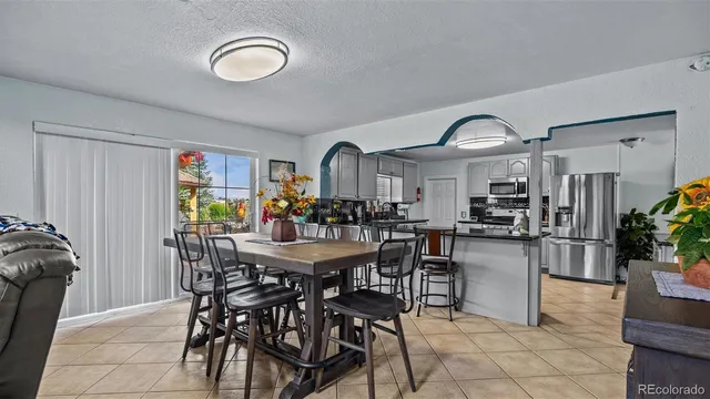 a view of a dining room with furniture and chandelier
