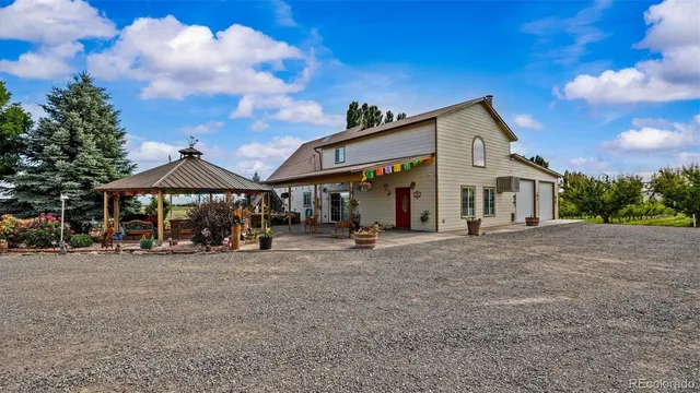 a view of a house with sitting area and covered with trees