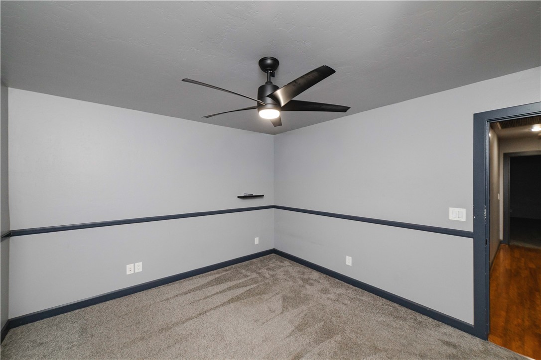 3374 Roma Road Kingman, AZ 86401 - Photo 37 of 64 Empty room with light carpet and a ceiling fan