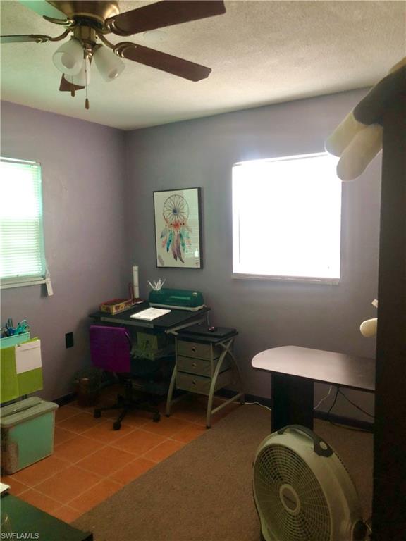 19 Massachusetts Road Lehigh Acres, FL 33936 - Photo 12 of 20 a living room with furniture and a window
