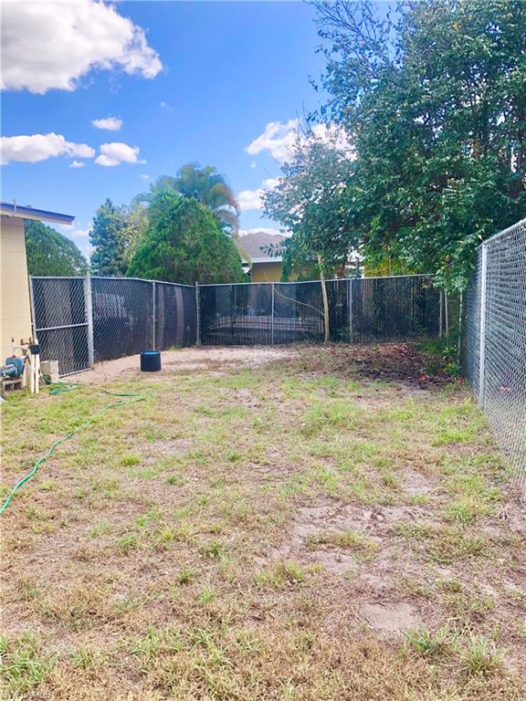 19 Massachusetts Road Lehigh Acres, FL 33936 - Photo 16 of 20 a swimming pool with wooden fence