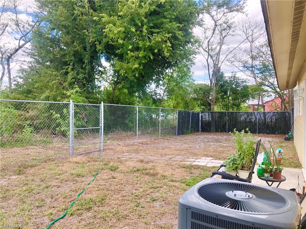 19 Massachusetts Road Lehigh Acres, FL 33936 - Photo 17 of 20 a backyard of a house with table and chairs