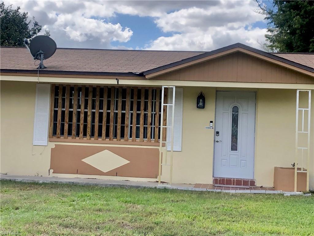 19 Massachusetts Road Lehigh Acres, FL 33936 - Photo 2 of 20 a view of front of a house with a yard