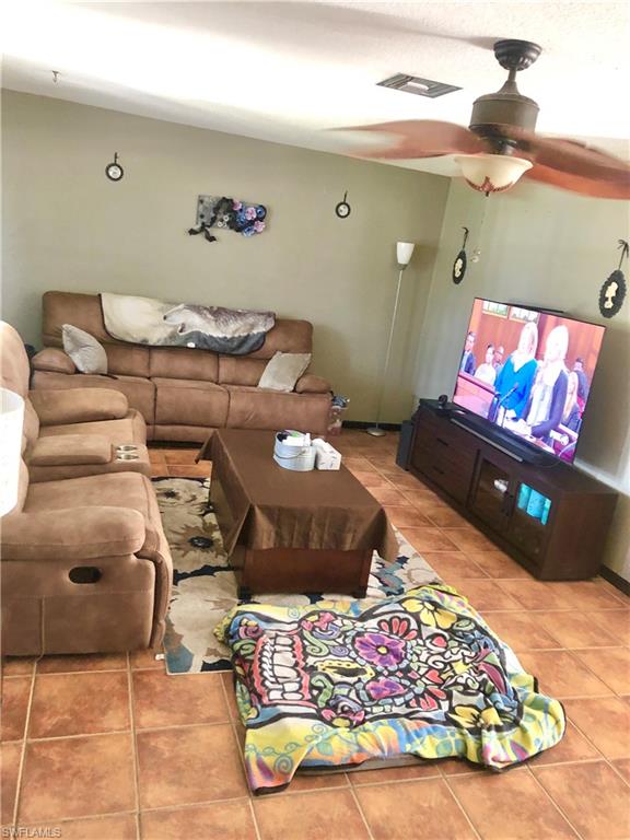 19 Massachusetts Road Lehigh Acres, FL 33936 - Photo 4 of 20 a living room with furniture and a couch