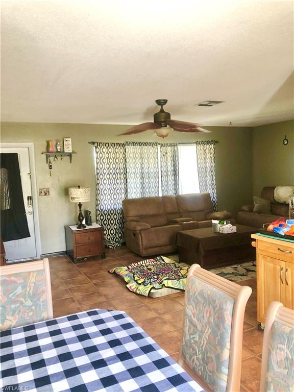 19 Massachusetts Road Lehigh Acres, FL 33936 - Photo 5 of 20 a bed room with a bed and a couch