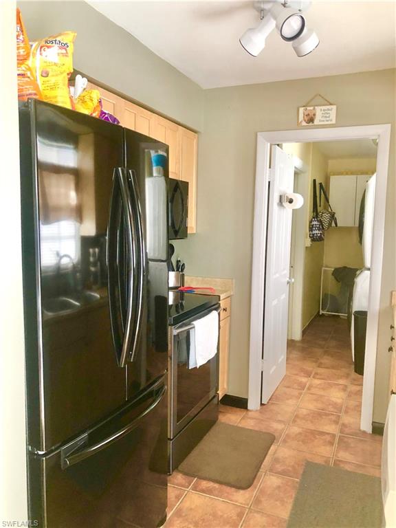 19 Massachusetts Road Lehigh Acres, FL 33936 - Photo 8 of 20 a view of a refrigerator in kitchen and livingroom