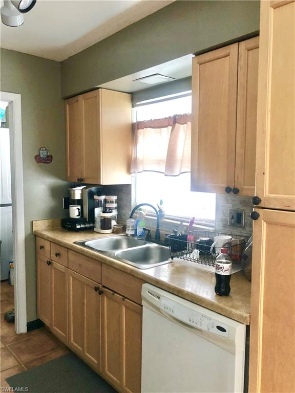 19 Massachusetts Road Lehigh Acres, FL 33936 - Photo 9 of 20 a kitchen with a sink cabinets and window
