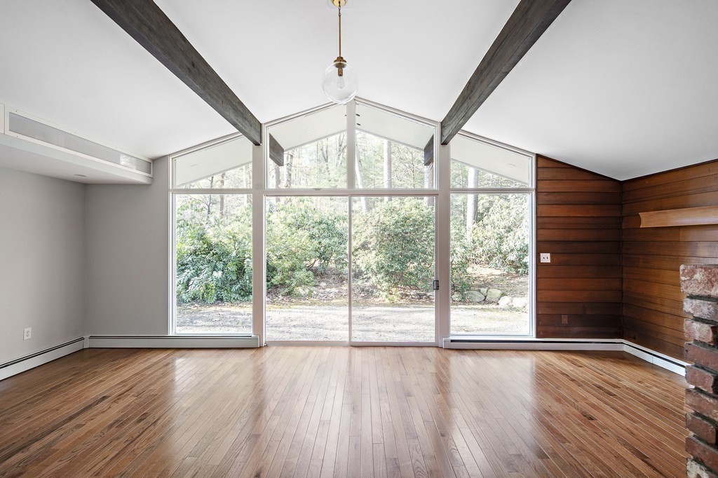 39 Turning Mill Road Lexington, MA 02420 - Photo 8 of 25 a view of an empty room with wooden floor and a window