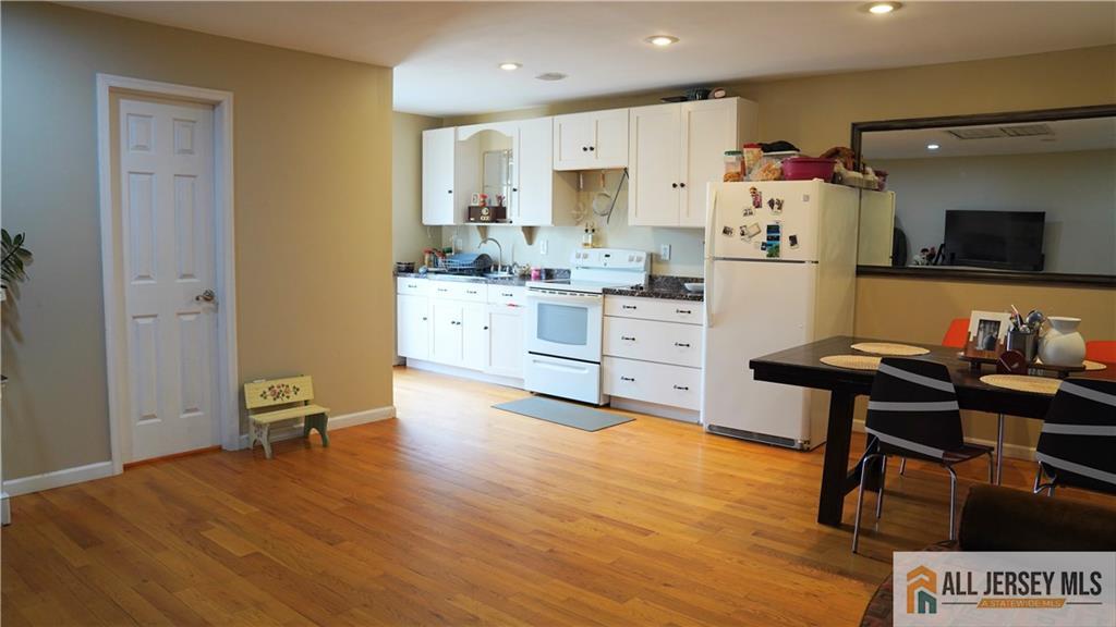 226 Gravel Hill Road Monroe Township, NJ 08831 - Photo 9 of 9 a living room with kitchen island granite countertop furniture and a refrigerator