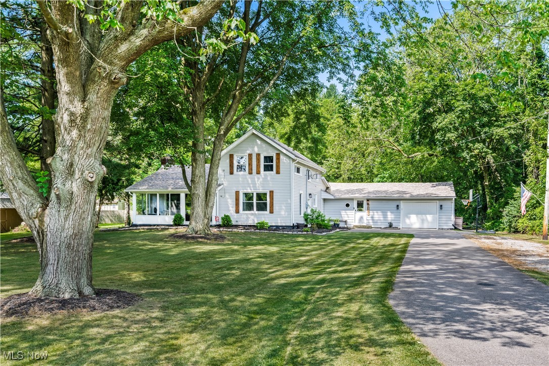 6170 Oberlin Road Amherst, OH 44001 - Photo 6 of 39 Traditional home featuring asphalt driveway, a front lawn, and a garage