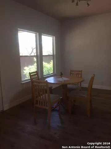 a workspace with furniture window and wooden floor