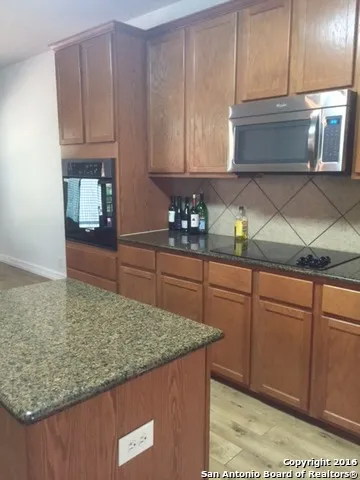 a kitchen with granite countertop cabinets and sink