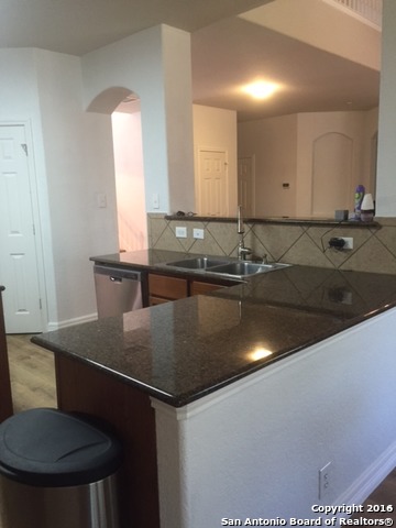 25914 Mission Bluff Boerne, TX 78015 - Photo 8 of 16 a kitchen with a sink granite counter tops and a view of living room