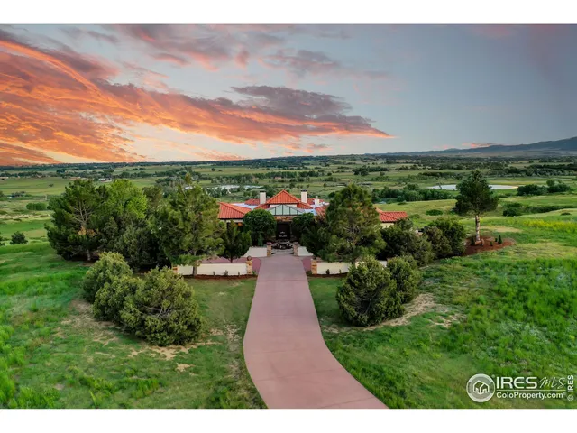 a large kitchen with stainless steel appliances a large counter top a stove a chimney a sink and cabinets